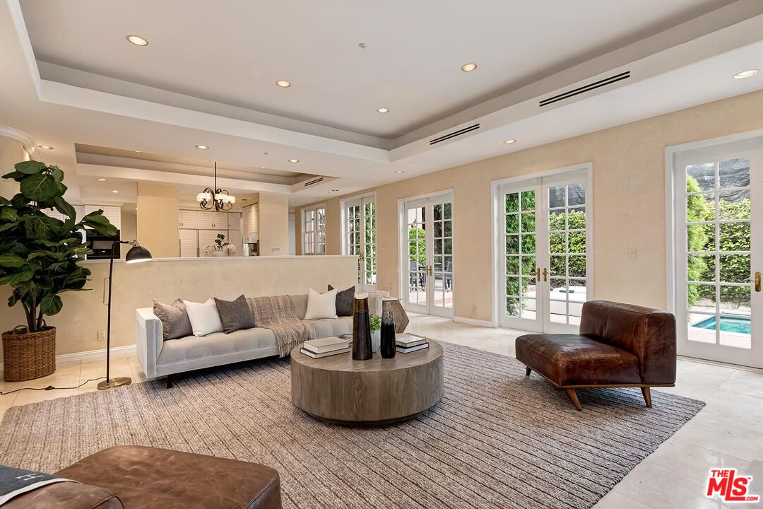 110 North Oakhurst Drive Beverly Hills, CA 90210 - Photo 9 of 29 a living room with furniture and a large window