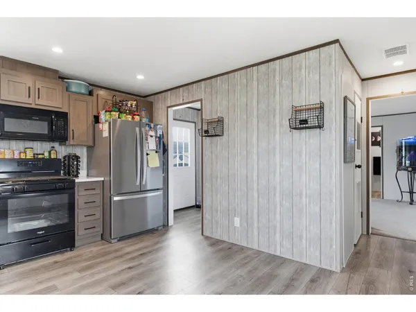 a kitchen with stainless steel appliances a refrigerator and a stove top oven