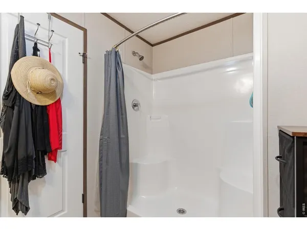 a bathroom with a mirror and a shower
