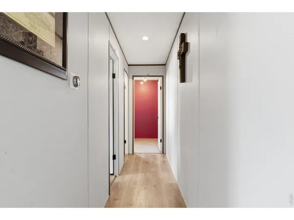 a view of a hallway with wooden floor