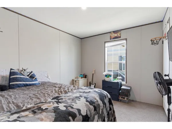 a bedroom with a bed a table and chair