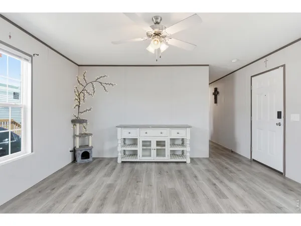 wooden floor in an empty room with a window