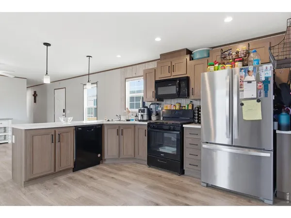 a kitchen with stainless steel appliances a refrigerator sink and microwave