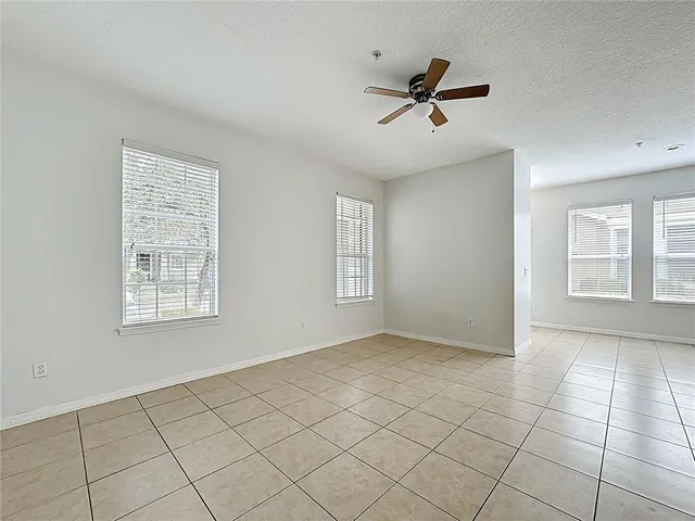 a view of a livingroom with a ceiling fan and window