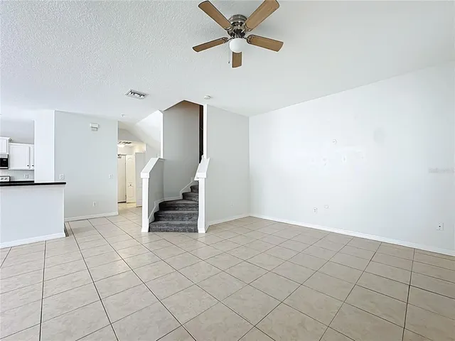 a view of a kitchen with an empty space and a window