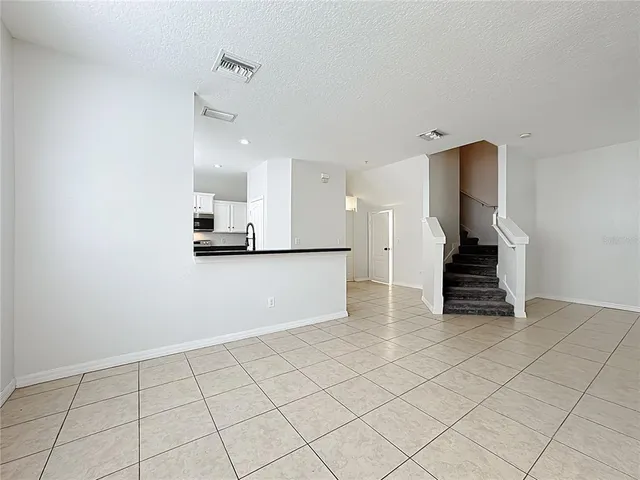 a kitchen with granite countertop white cabinets and a sink