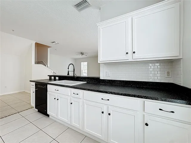 a kitchen with cabinets stainless steel appliances and a window