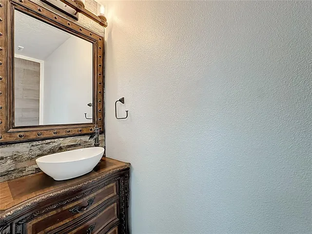an empty room with a chandelier fan and closet
