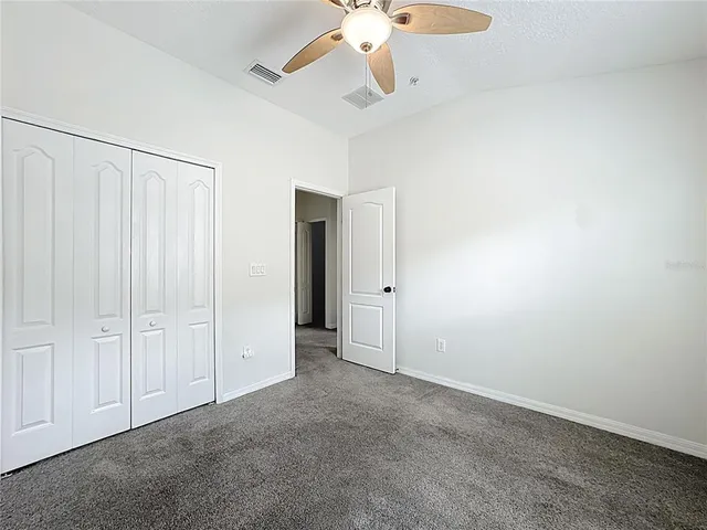 a spacious bathroom with a toilet sink and mirror