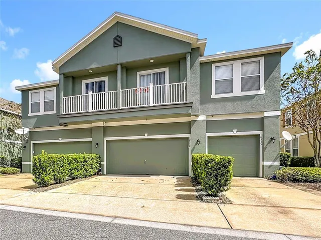 an aerial view of multiple houses with a yard