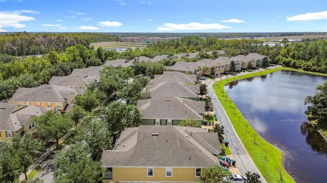 an aerial view of multiple houses with a yard