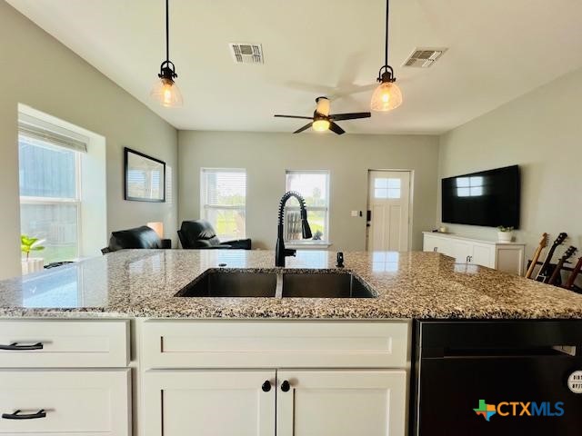 2824 Harrison Avenue Port O'Connor, TX 77982 - Photo 12 of 48 a kitchen with granite countertop a sink and a flat screen tv