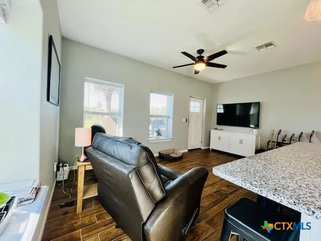 a living room with furniture and a flat screen tv