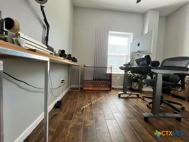 a view of workspace with wooden floor and gym equipment