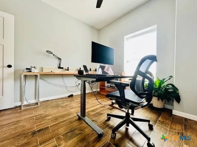 a workspace with furniture and wooden floor