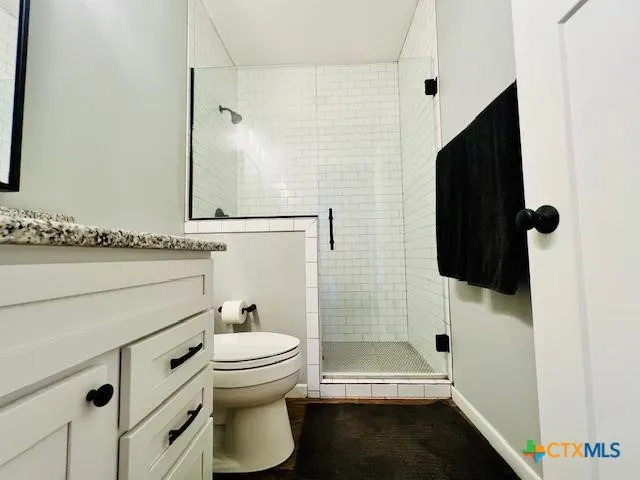a bathroom with a toilet and a shower