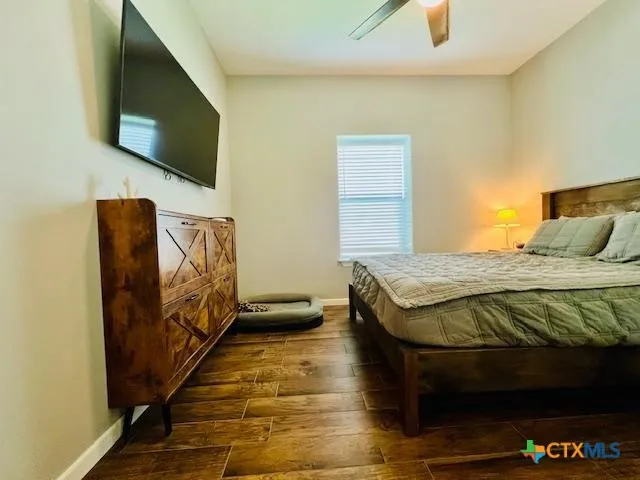 a bedroom with a bed and flat screen tv