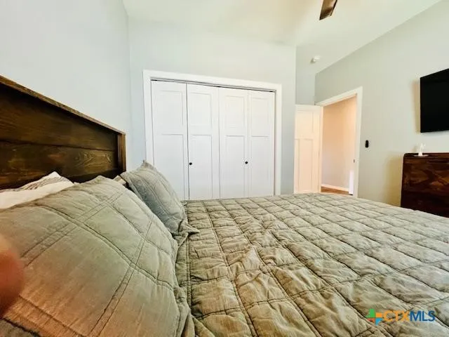 a bed sitting in a bedroom and a flat screen tv