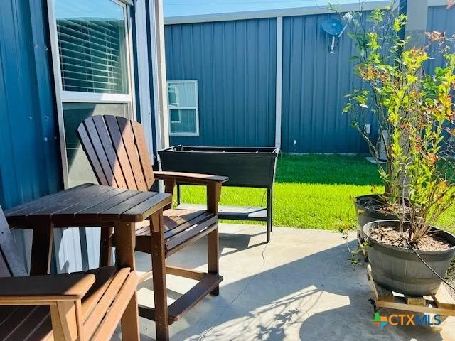 a backyard of a house with table and chairs