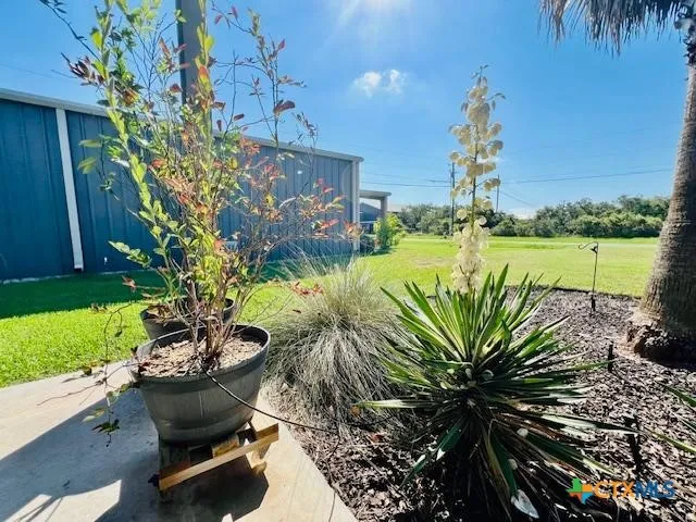 a swimming pool with outdoor seating and garden