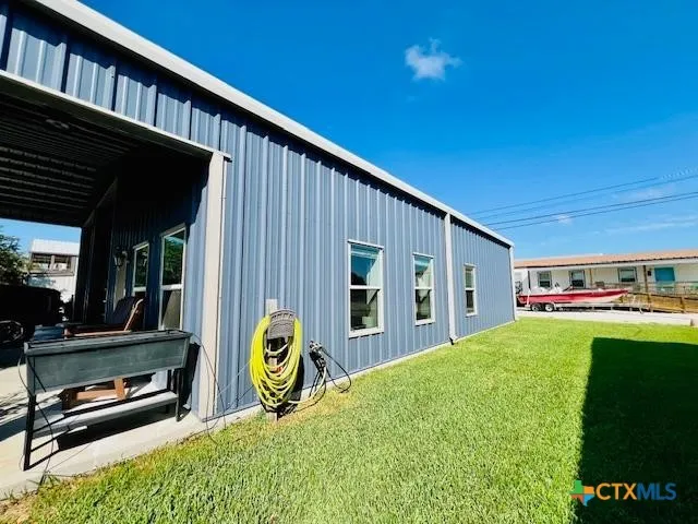 a view of backyard with hardwood area
