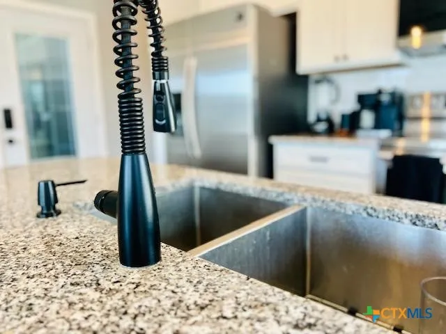 a kitchen with granite countertop a sink and a stove