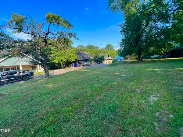 a view of yard with swimming pool and green space