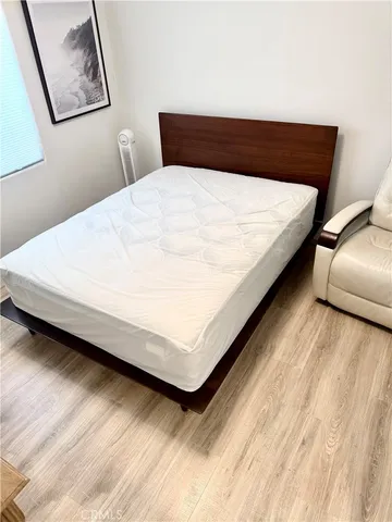 a large bed sitting in a bedroom next to a window