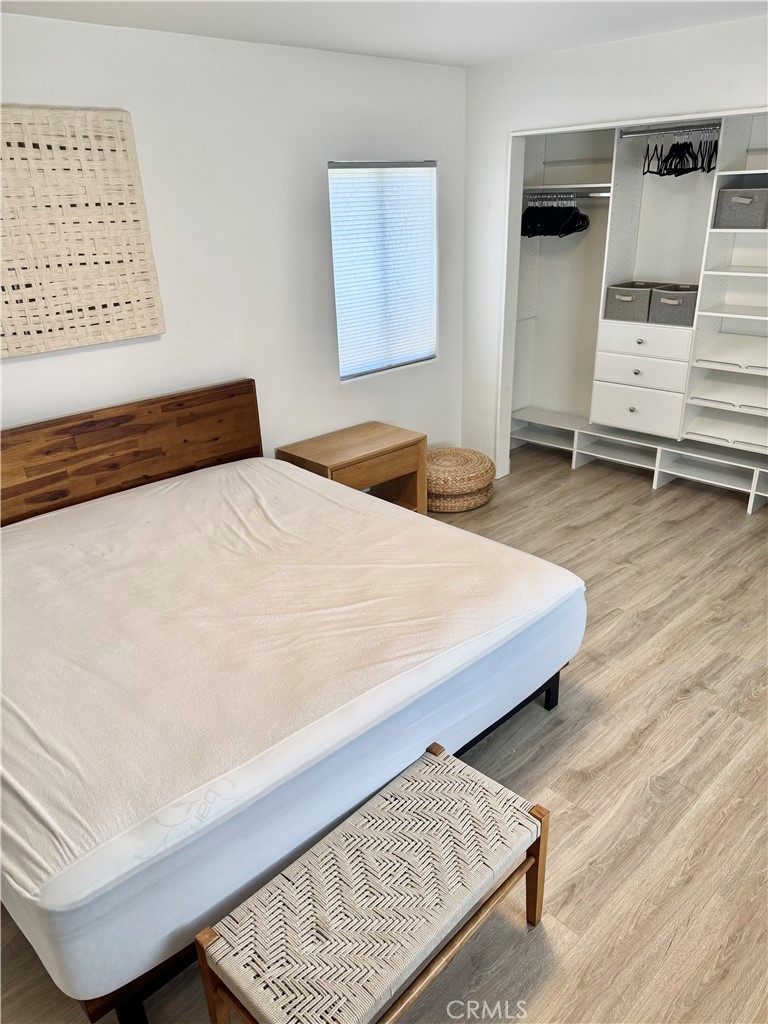 18913 Haas Avenue Torrance, CA 90504 - Photo 18 of 20 a bedroom with a bed and a wooden floor