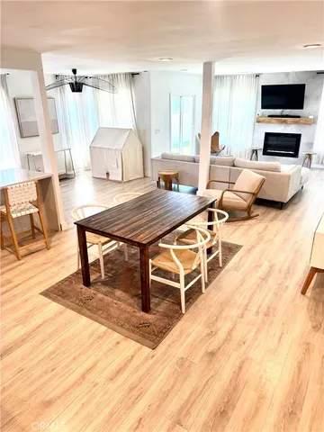 a living room with furniture a flat screen tv and a table