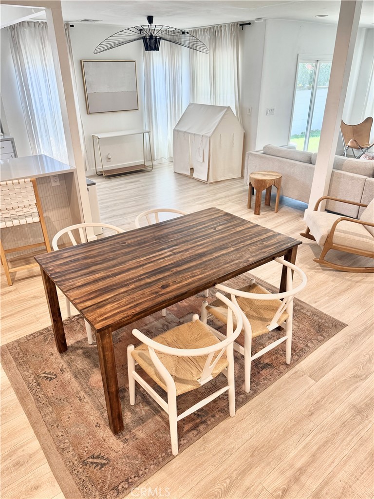 18913 Haas Avenue Torrance, CA 90504 - Photo 4 of 20 a living room with a couch a rug kitchen view and a large window