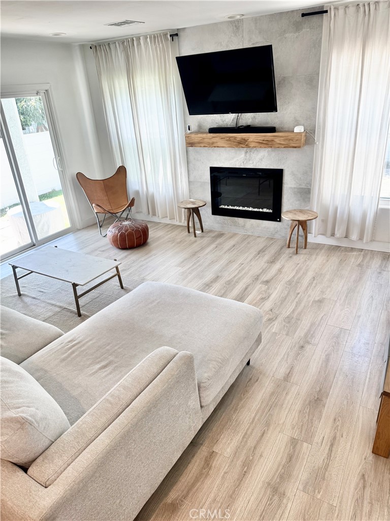 18913 Haas Avenue Torrance, CA 90504 - Photo 7 of 20 a living room with furniture a fireplace and a flat screen tv