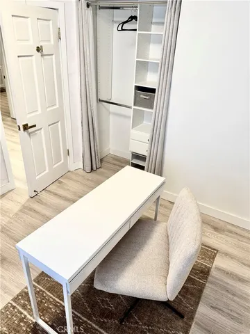 a living room with a bed and a refrigerator