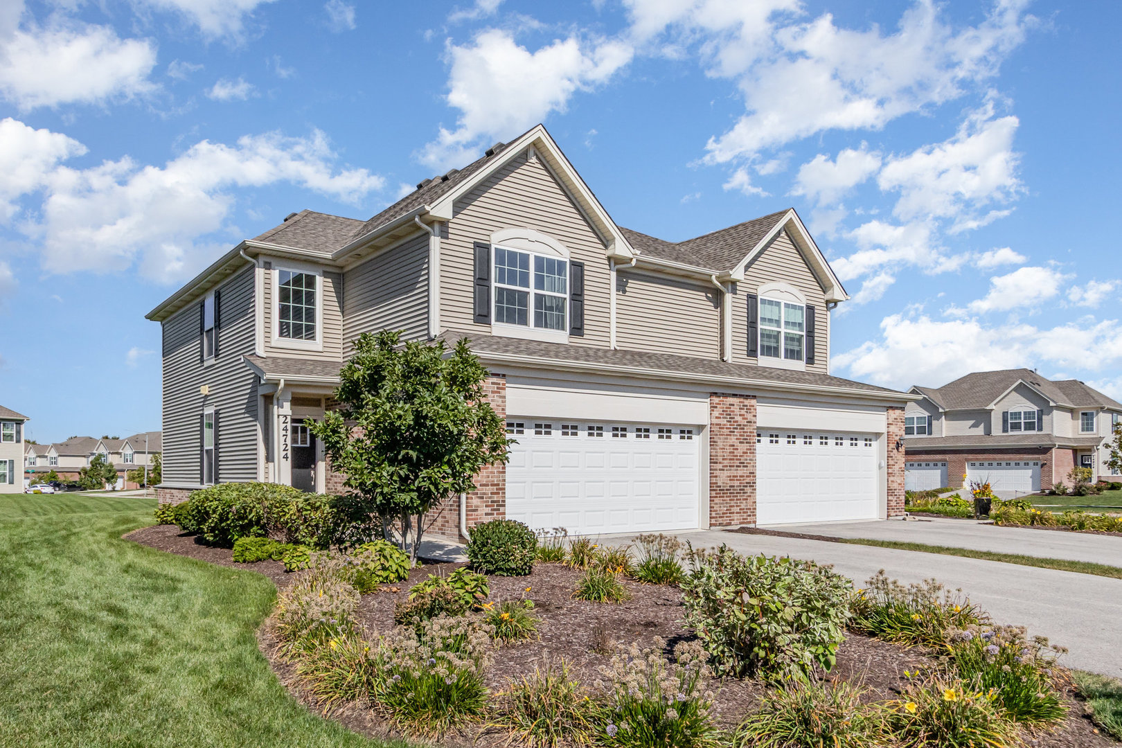 24724 McCormick Way Manhattan, IL 60442 - Photo 1 of 24 a front view of a house with a yard and garage