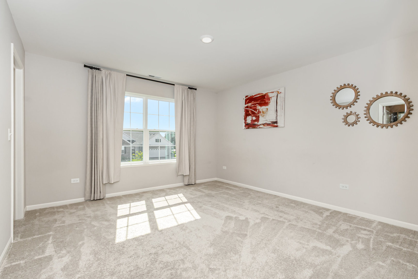 24724 McCormick Way Manhattan, IL 60442 - Photo 19 of 24 an empty room with windows and fan