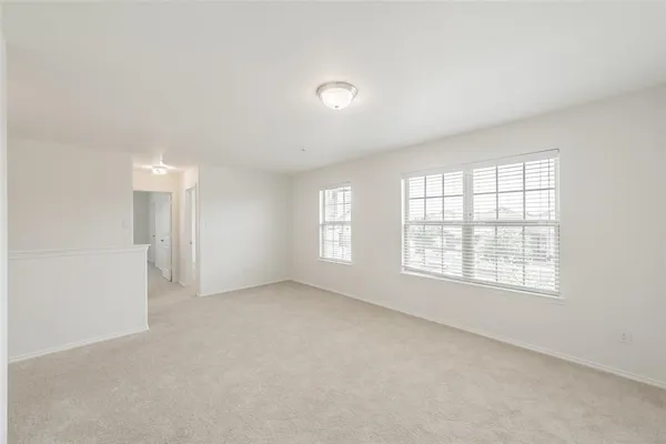 an empty room with a empty space and windows
