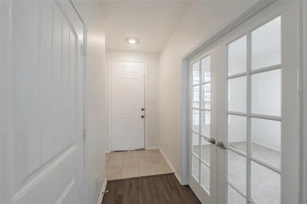 a view of a room with wooden floor and windows