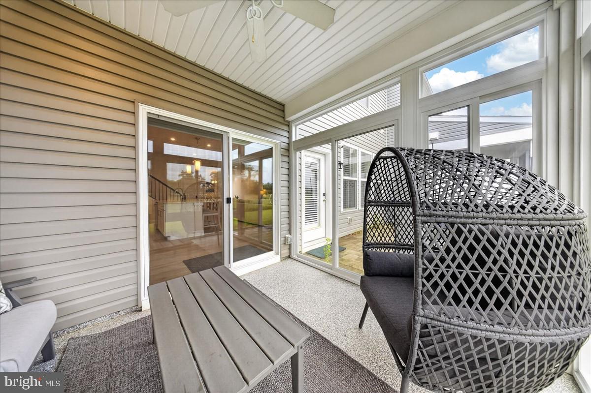 38023 Cross Gate Road Millville, DE 19967 - Photo 10 of 37 a view of a porch with wooden floor and furniture