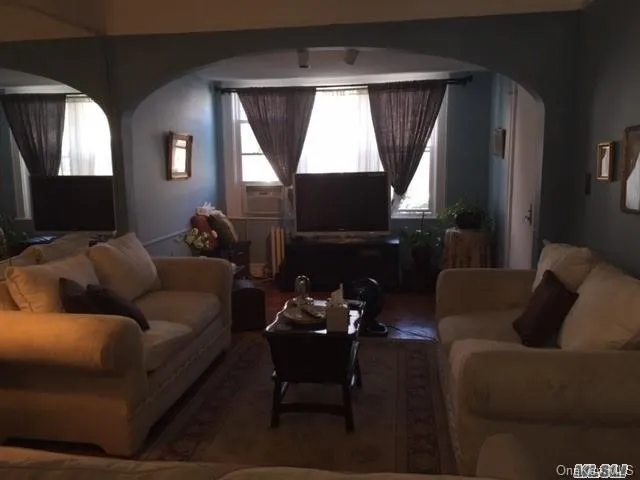 a living room with furniture and a flat screen tv