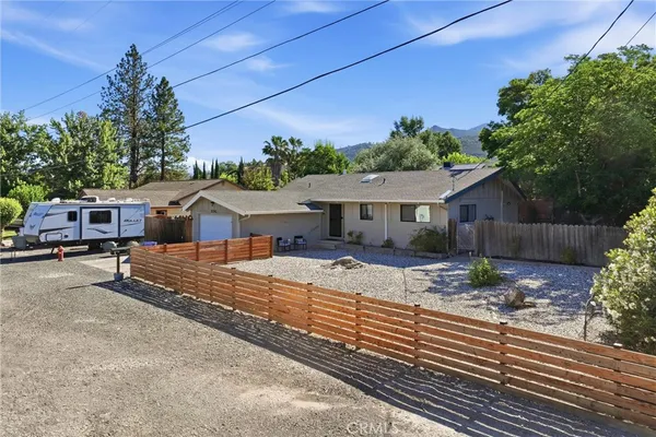 a view of a house with backyard and sitting area