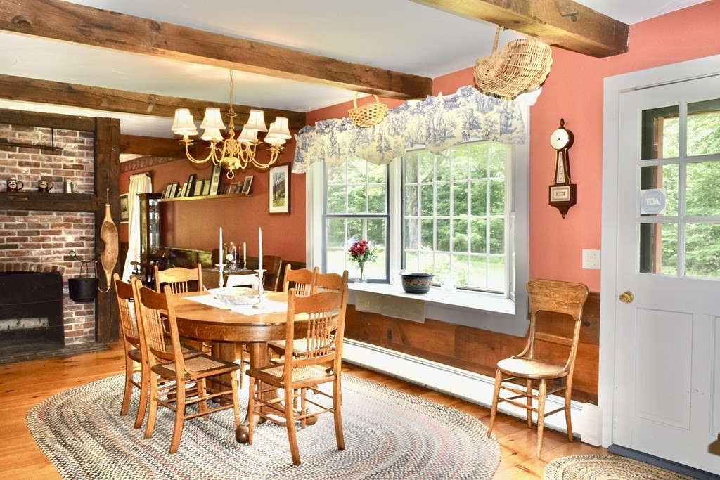62 West Branch Road Ashfield, MA 01330 - Photo 13 of 42 a view of a dining room with furniture wooden floor and a chandelier