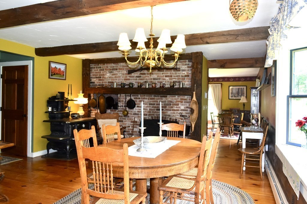 62 West Branch Road Ashfield, MA 01330 - Photo 14 of 42 a view of a dining room with furniture wooden floor and a chandelier