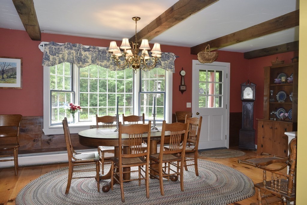 62 West Branch Road Ashfield, MA 01330 - Photo 17 of 42 a view of a dining room with furniture wooden floor and chandelier