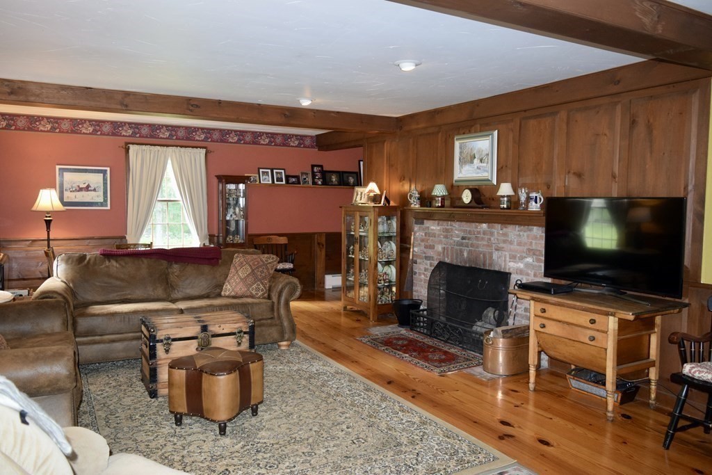 62 West Branch Road Ashfield, MA 01330 - Photo 20 of 42 a living room with furniture a flat screen tv and a fireplace