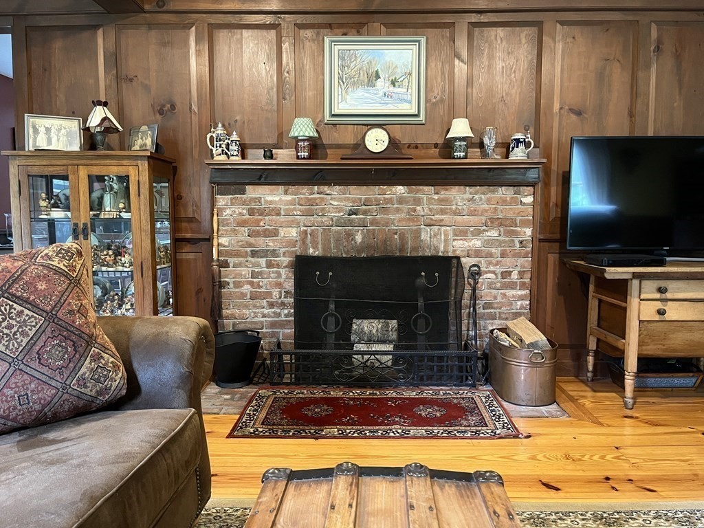 62 West Branch Road Ashfield, MA 01330 - Photo 21 of 42 a living room with furniture a flat screen tv and a fireplace