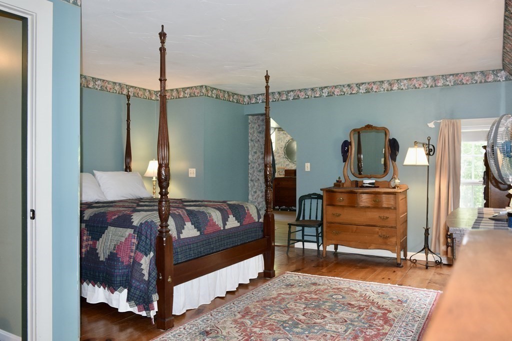 62 West Branch Road Ashfield, MA 01330 - Photo 26 of 42 a bedroom with furniture and a wooden floor