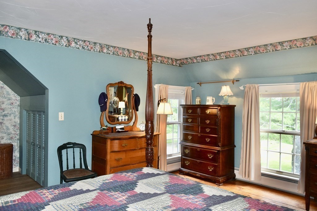 62 West Branch Road Ashfield, MA 01330 - Photo 27 of 42 a bedroom with a bed closet and flat tv screen