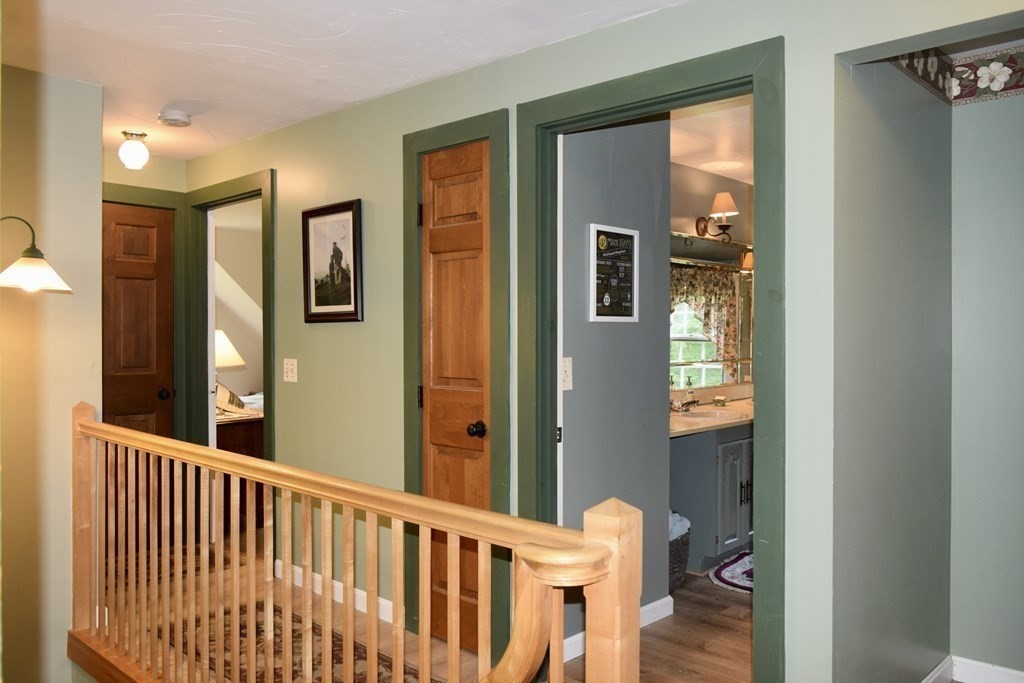 62 West Branch Road Ashfield, MA 01330 - Photo 32 of 42 a view of a hallway with wooden floor and a living room