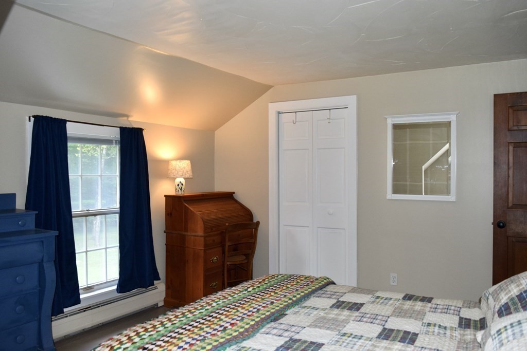 62 West Branch Road Ashfield, MA 01330 - Photo 36 of 42 a bedroom with a bed and wooden floor