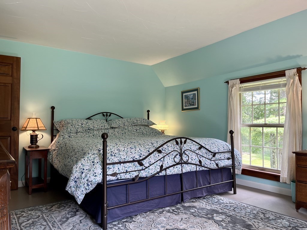 62 West Branch Road Ashfield, MA 01330 - Photo 37 of 42 a bedroom with a bed and wooden floor